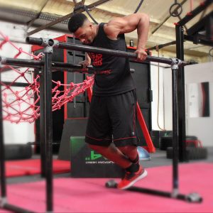 Adult calisthenics class demonstrating parallel bar dip